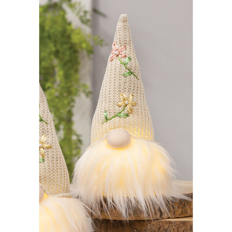 Gnome de printemps illuminé assis