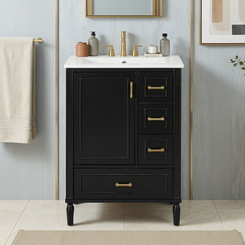 Meuble-lavabo avec lavabo simple en céramique, 3 tiroirs à fermeture amortie, poignées en alliage de zinc doré et tablette de rangement intégrée à la porte.