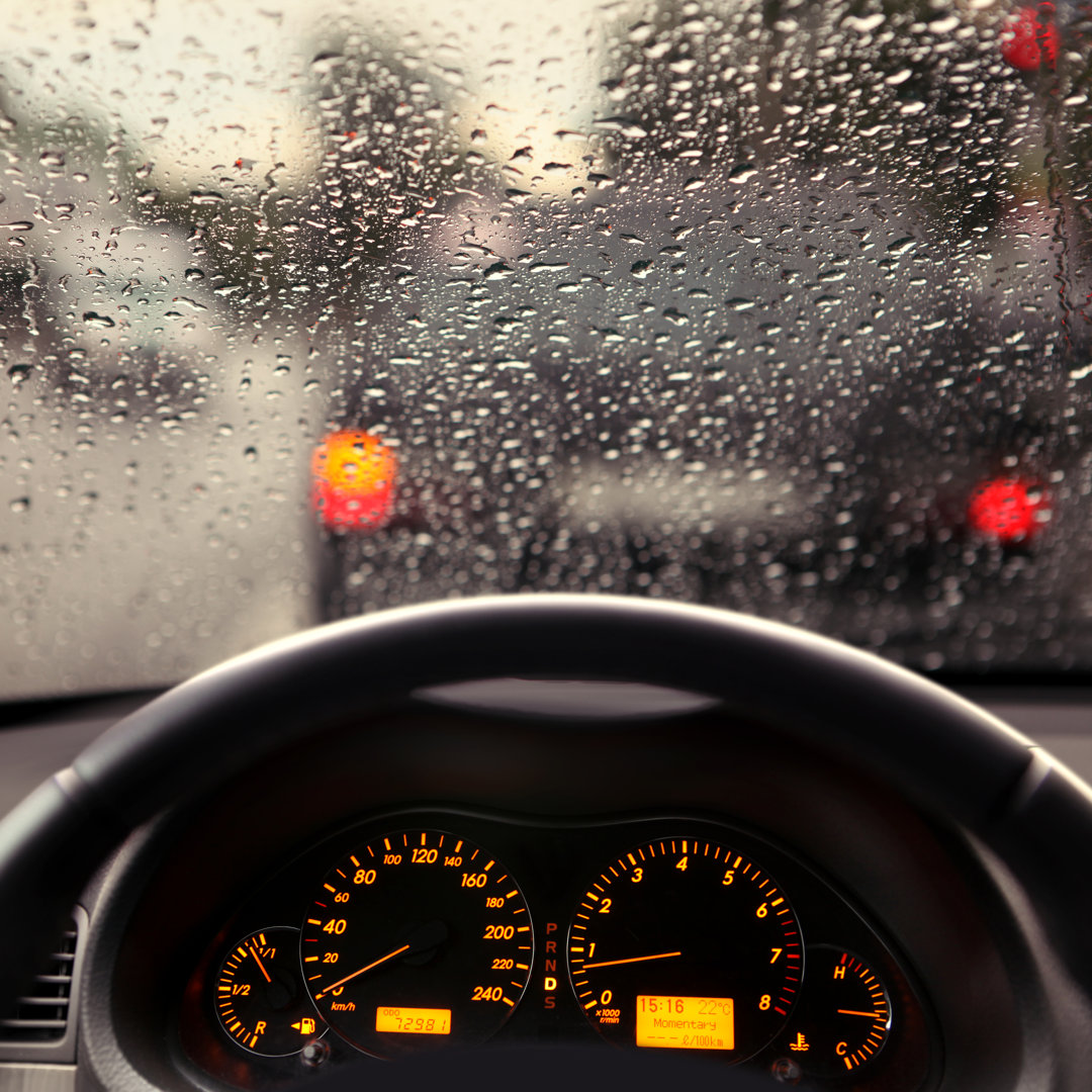 Leinwandbild Regentropfen auf der Windschutzscheibe eines Autos