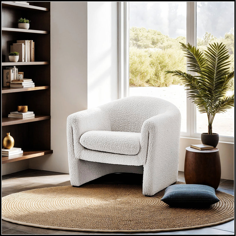Fauteuil d'appoint compact contemporain en forme de U, recouvert de tissu bouclé, idéal pour les salons modernes et offrant une assise confortable et élégante.