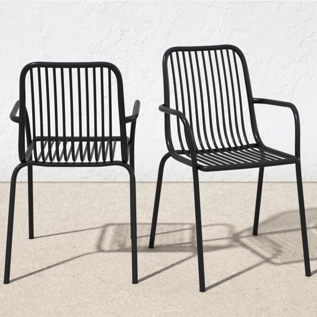 Two black metal outdoor dining chairs with armrests.