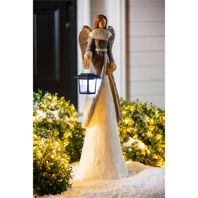 Statue d’ange d’hiver avec lanterne solaire
