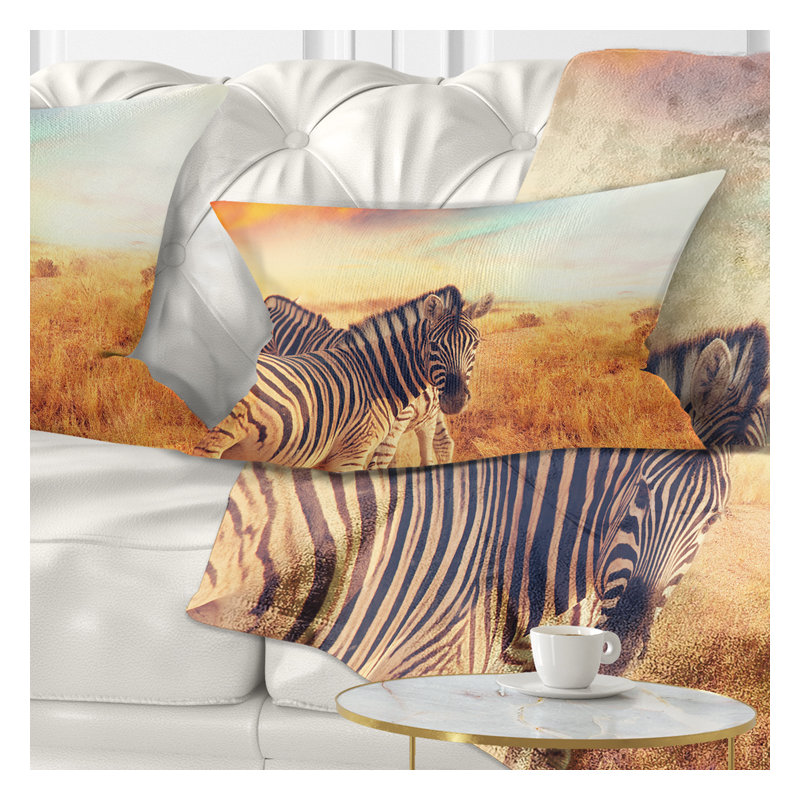 Coussin lombaire zèbres de troupeau dans le terrain sur le coucher du soleil