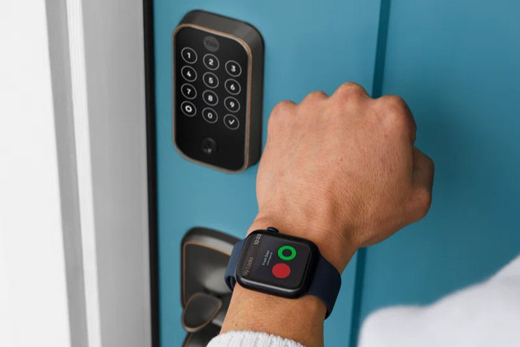 person unlocking their front door smart lock with a smart watch