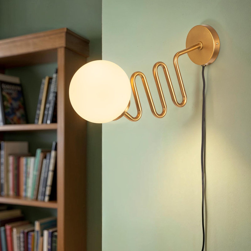 Metal And Glass Wall Sconce With Glass Orb Globe, Curved Base And Inline Switch
