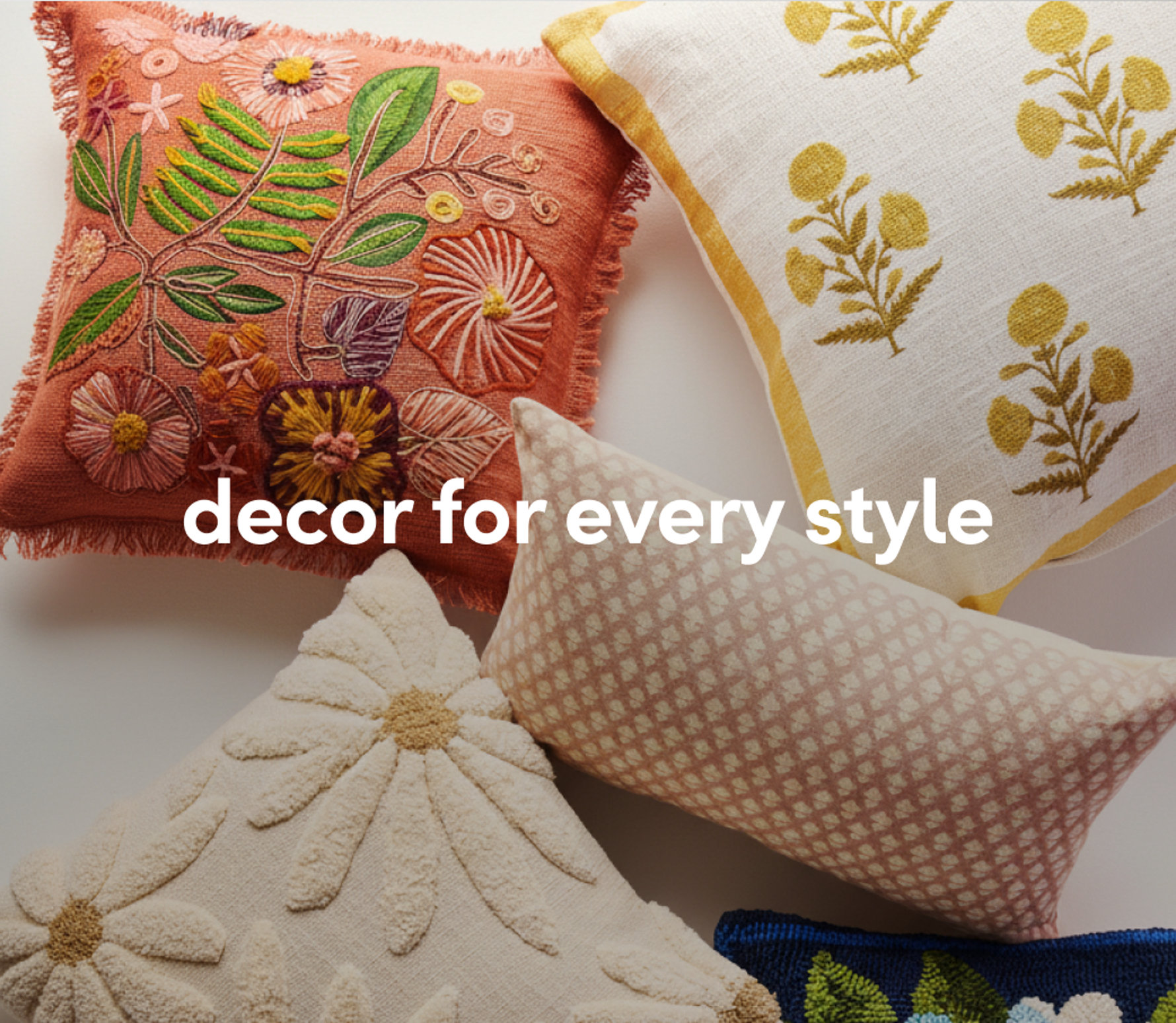 Colorful decorative throw pillows in various patterns and textures on a couch.