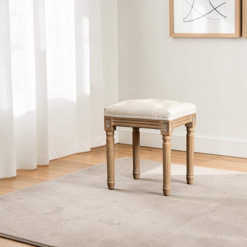 Tabouret de coiffeuse Fornear en lin, pieds en bois massif sculpté, banc de toilette au design capitonné, Beige