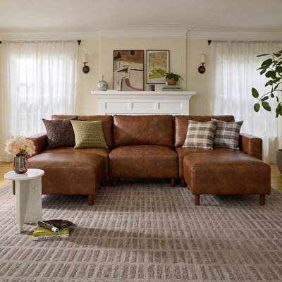 Canapé trois places Modulair moderne et luxueux avec deux poufs, recouvert de cuir PU respirant et doté d'une structure en bois massif.