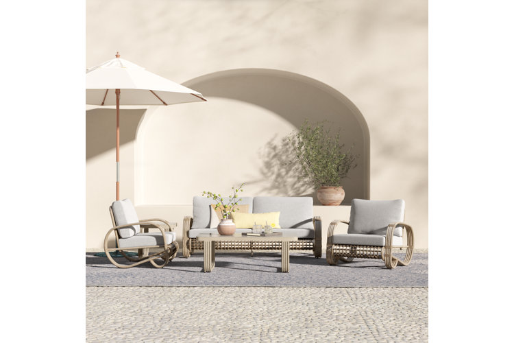 outdoor patio space with a gray patio set and white umbrella