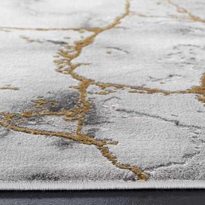 Tapis gris et or à motif abstrait Swindle