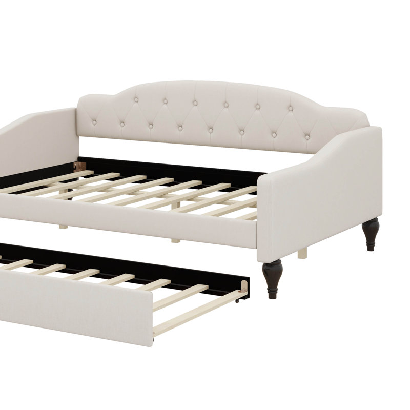 A Full-Size Upholstered Daybed With Tufted Design And A Built-In Twin-Size Trundle Bed