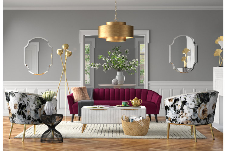 Glam living room with soft gray walls, a magenta sofa, and floral upholstered chairs.