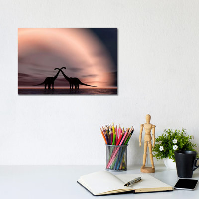 The Silhouetted Forms Of A Pair Of Courting Sauropod Dinosaurs by Mark Stevenson - Wrapped Canvas Print