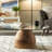 Verniece Coffee Table Wood Glass Metal Base Modern Sculptural Design with Sleek Round Top and Decorative Mixed-Material Construction for Contemporary Versatile Living Room Appeal