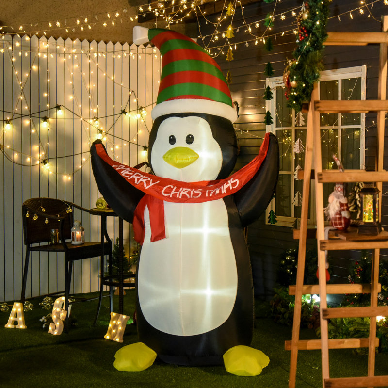 Pingouin tenant une bannière gonflable Merry Christmas