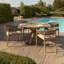 Aderita 4 - Person Acacia Solid Wood Patio Dining Set Round Table with Cushions Included