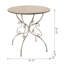 Table ronde en bois avec pieds à volutes en métal, blanc