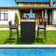 Ensemble de salle à manger de patio en osier pour 4 personnes avec table rectangulaire Arnisa, coussins inclus