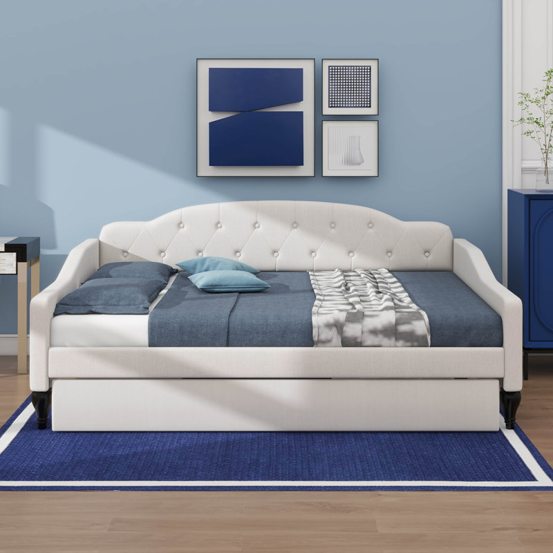 A Full-Size Upholstered Daybed  Integrated Twin-Size Trundle