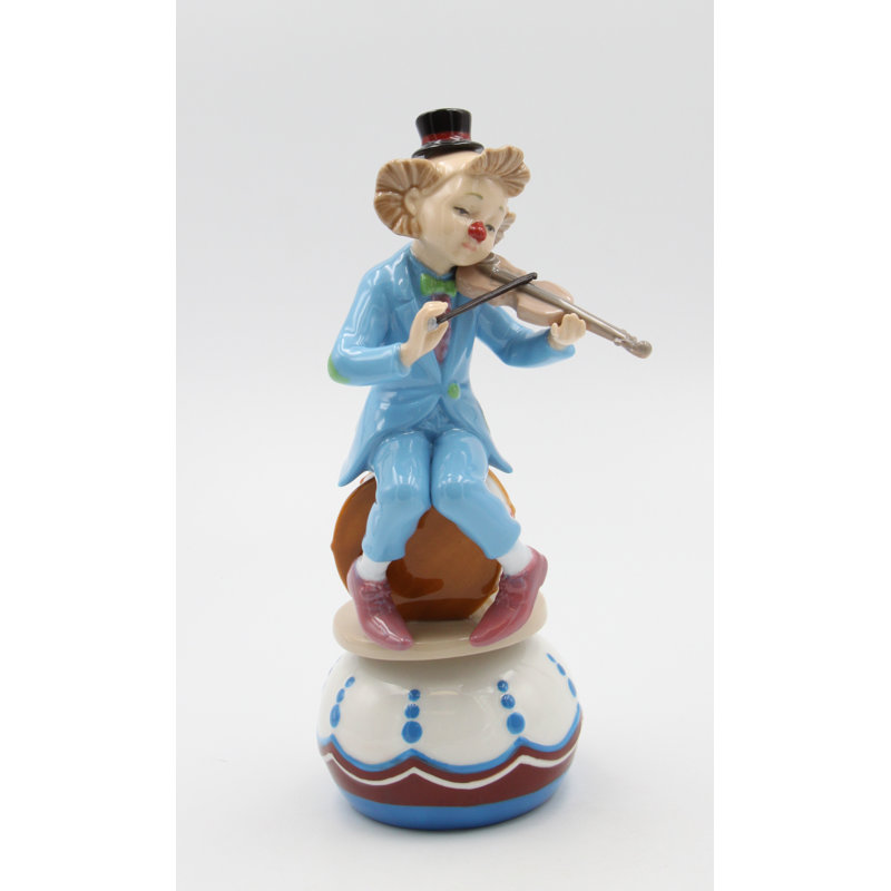 Figurine clown jouant de la musique