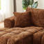 Chenille orange à 4 places en forme de L avec un design segmenté, une structure à ressorts ensachés et un arrangement polyvalent pour les espaces de vie.