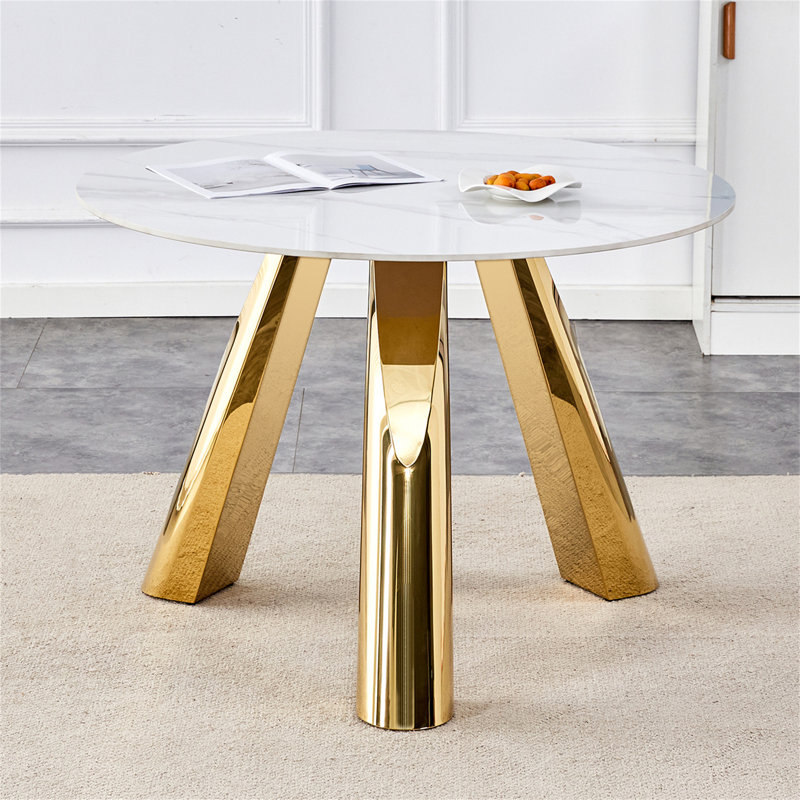 Une table ronde à pieds en acier inoxydable de 42 pouces avec un plateau en marbre convient à une utilisation par 4 à 6 personnes