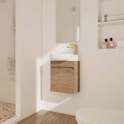 Meuble-lavabo mural compact avec portes à fermeture en douceur et lavabo en céramique, parfait pour les petits espaces