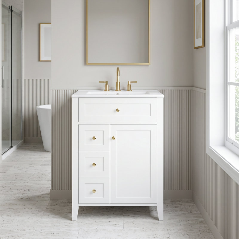 Meuble-lavabo autoportant en MDF blanc de 61 cm (24 po) avec lavabo en céramique, poignées en métal, porte à fermeture amortie et tablette de rangement.