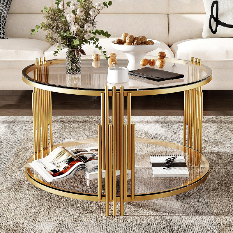 Table basse moderne en verre avec base asymétrique en métal, conception de tambour circulaire, finition dorée et tablette inférieure pour un rangement supplémentaire