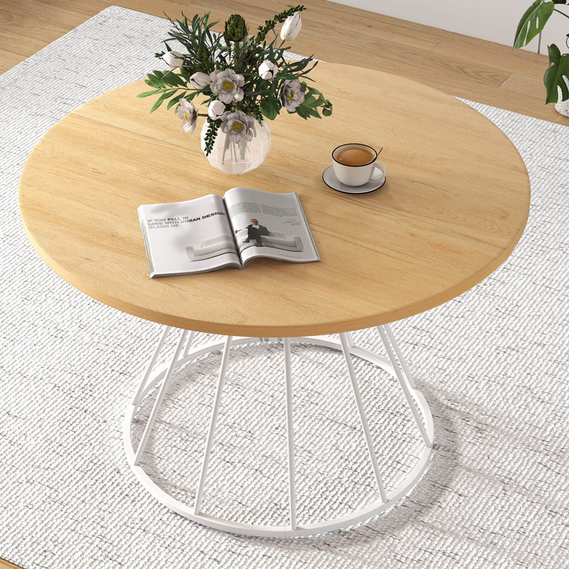 Table de salle à manger ronde de 119 cm (47 po) avec dessus en bois et piètement en métal, finition naturelle et blanche.
