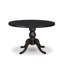 Une table en bois avec un plateau de table rond et un piédestal élégant au fini noir sablé.-1154334047-1154334041-1156809875