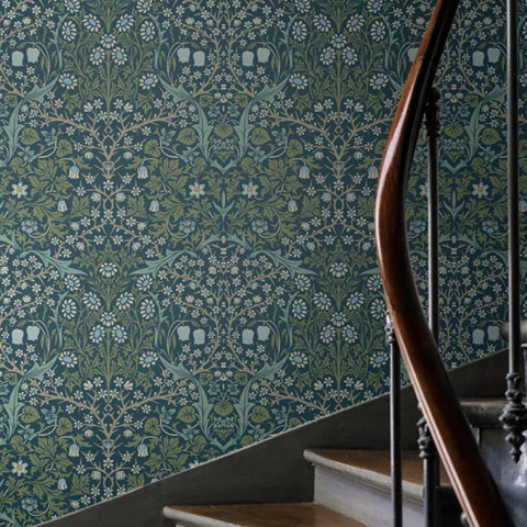 Floral wallpaper behind staircase.