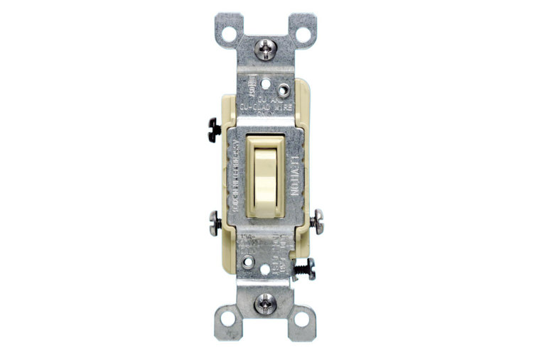 Type of light switch called a toggle switch displayed without its decorative switch plate so you can see the terminal screws.