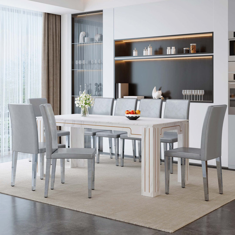 Ensemble repas luxueux avec table en imitation marbre et chaises en polyuréthane