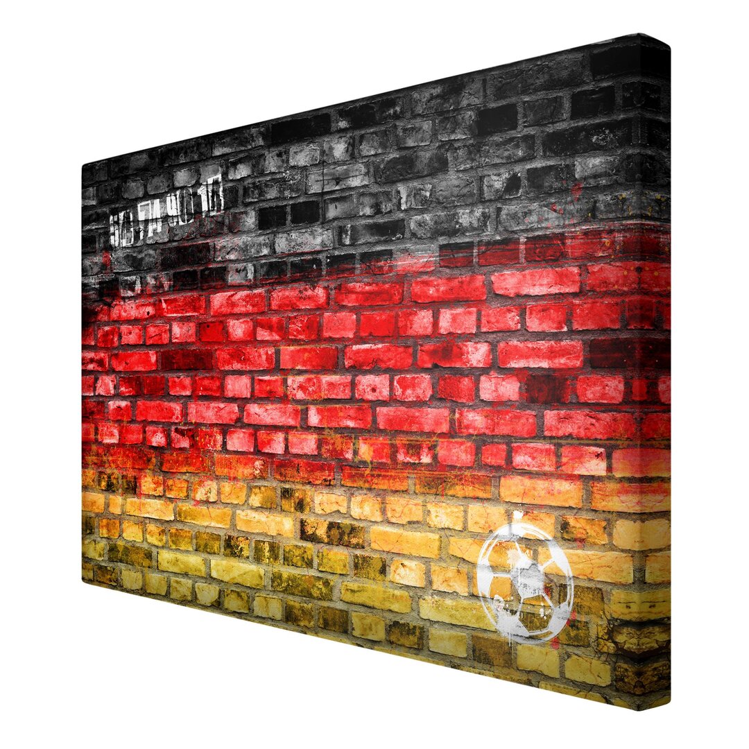 Leinwandbild Steinwand mit Deutschlandfarben