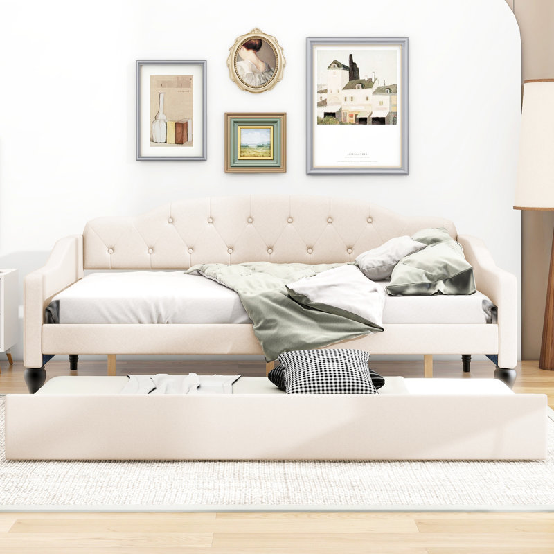 A Full-Size Upholstered Daybed With Tufted Design And A Built-In Twin-Size Trundle Bed