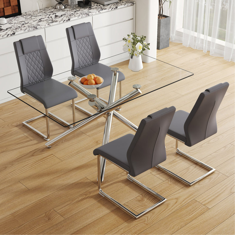 Table And Chair Set.Modern Luxurious Transparent Tempered Glass Dining Table Set With 4 Chairs.Single Fork Silver Metal Table Legs.Dark Gray High-Quality PU Dining Chairs With Silver Metal Legs.