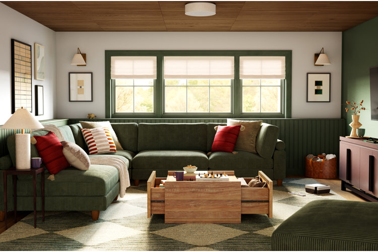 green living room with a dill green sectional and green patterned area rug