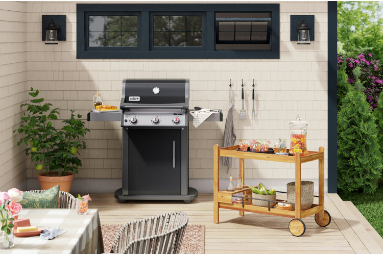 outdoor dining area with a grill and a rolling cart