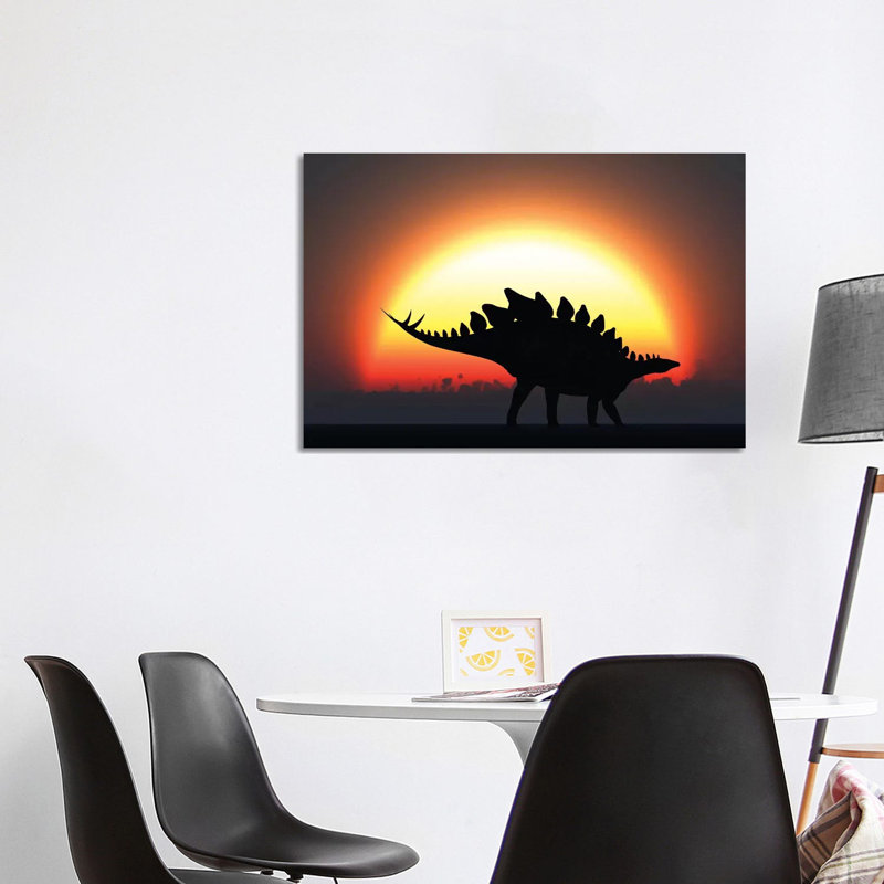 A Stegosaurus Silhouetted Against The Setting Sun At The End Of A Prehistoric Day by Mark Stevenson - Wrapped Canvas Print