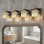 Luminaire de meuble-lavabo moderne en cristal noir et or avec abat-jour carré - applique murale à 4 lumières à intensité variable pour miroir