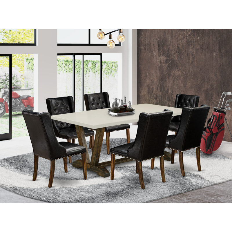Cet ensemble de table de salle à manger 9 pièces comprend une table rectangulaire en bois avec pieds en V et 8 chaises rembourrées en similicuir noir, en lin brossé blanc.