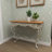 Aine Metal Scroll White Console Table with Brown Wood Top