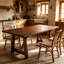 Table de salle à manger rectangulaire de style campagnard en bois massif, pouvant accueillir de 4 à 6 personnes.