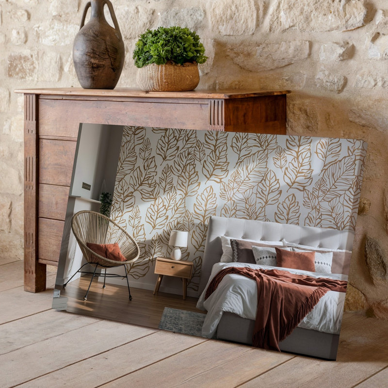 Toile une scène de chambre à coucher moderne et sereine avec un art mural texturé orné de grands motifs de feuilles élégantes