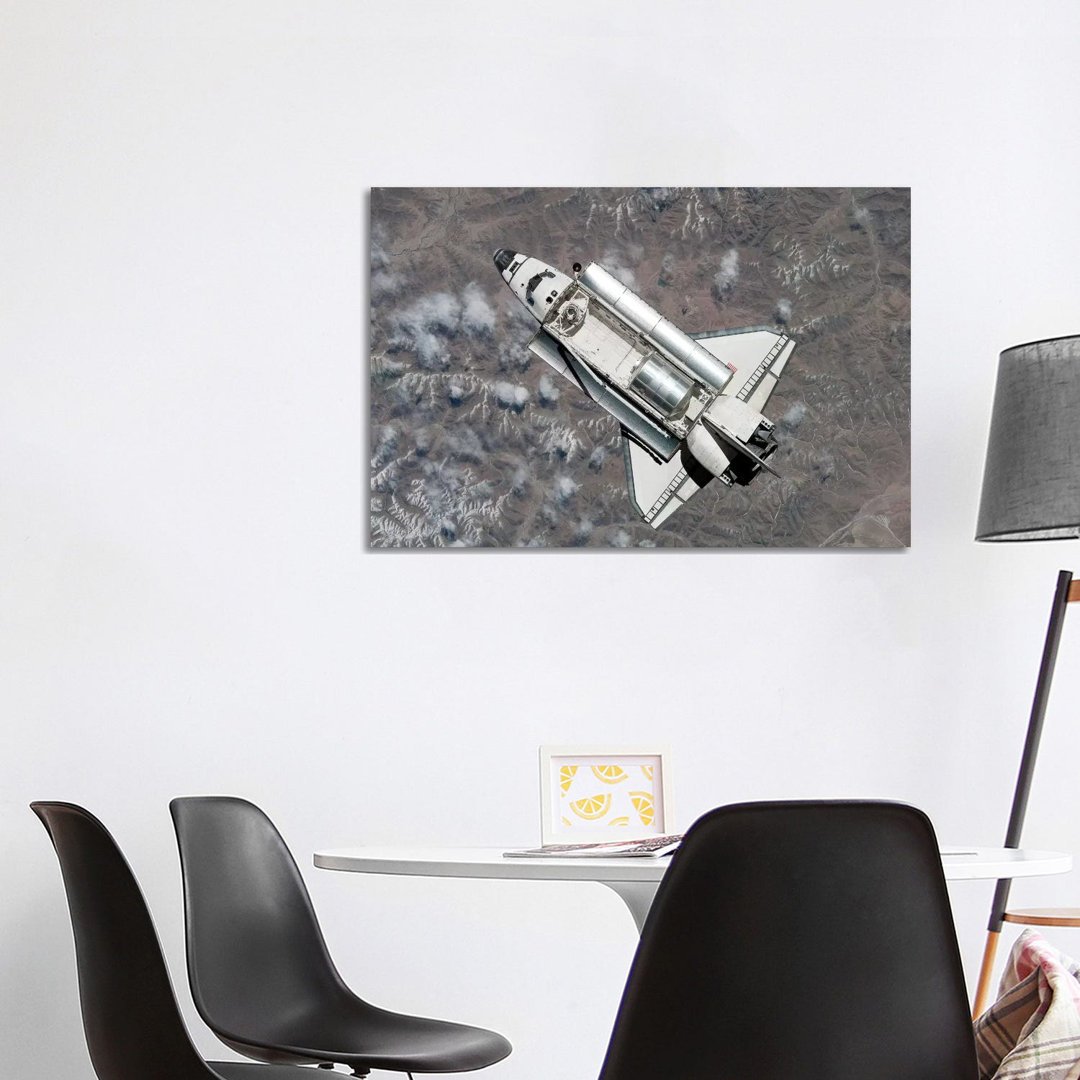 Aerial View Of Space Shuttle Discovery Over Earth As It Approaches The International Space Station by Stocktrek Images - Wrapped Canvas Print