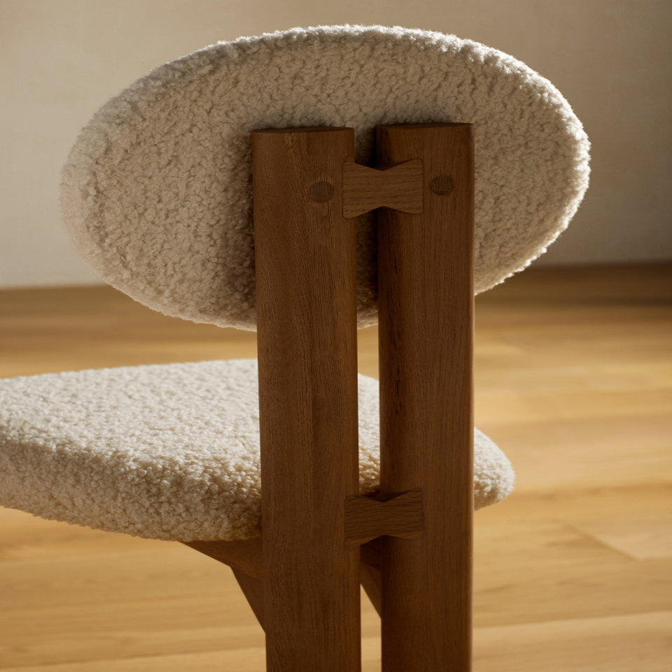 Close-up of a chair with a sherpa seat and back.