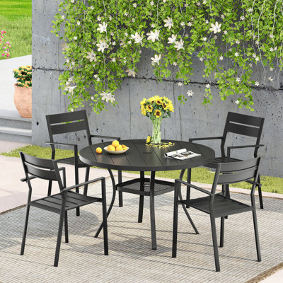 Patio dining set with Round Metal Dining Table and 4 Metal Armrest Dining Chairs by Lark Manor
