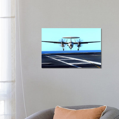 An E-2C Hawkeye Approaches For Landing Aboard USS John C. Stennis by Stocktrek Images - Wrapped Canvas Print