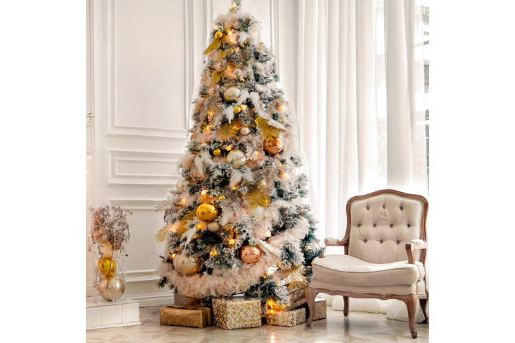 Elaborate Christmas tree with metallic gold, pink, and silver ornaments.